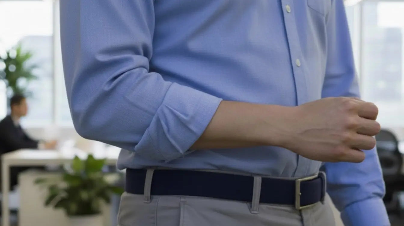 A light blue, long-sleeved button-up shirt with neatly rolled cuffs.