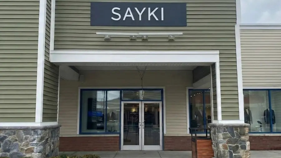The sayki store sign at wrentham village premium outlets sells tuxedos starting at 199.90 in bold white letters
