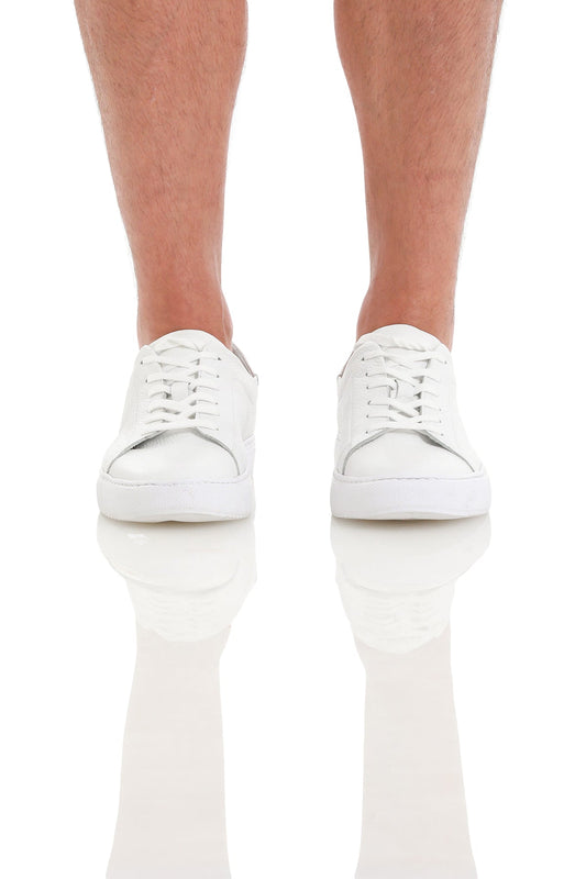 White leather low-top sneakers with clean, minimalist design.