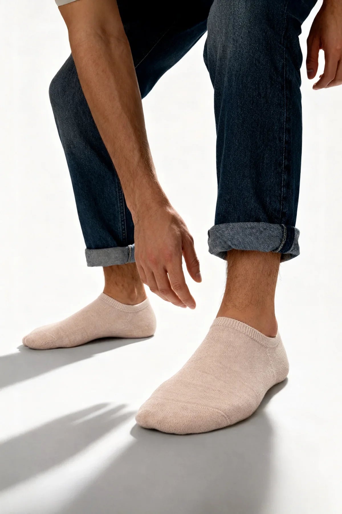 A pair of soft pale pink bamboo ankle socks with ribbed cuff and seamless construction no show design