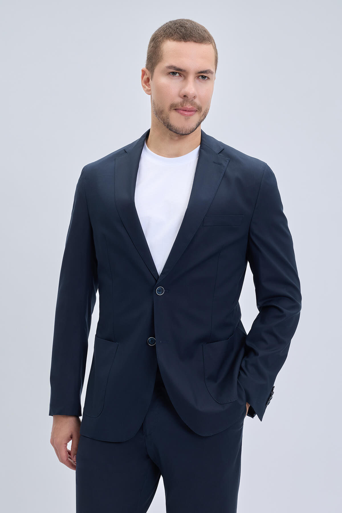 Navy blue slim fit notch lapel tailored suit jacket with sleek modern cut and subtle texture lightweight casual design