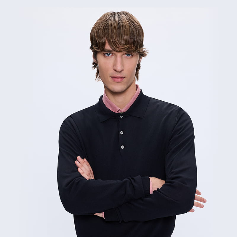 Man wearing black long sleeve polo layered over shirt, modern everyday gift style