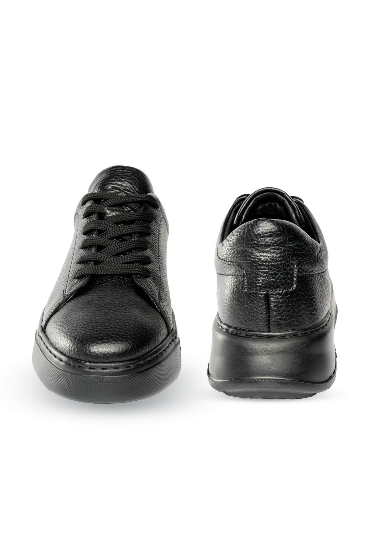 Black leather sneakers with a textured surface and chunky soles.