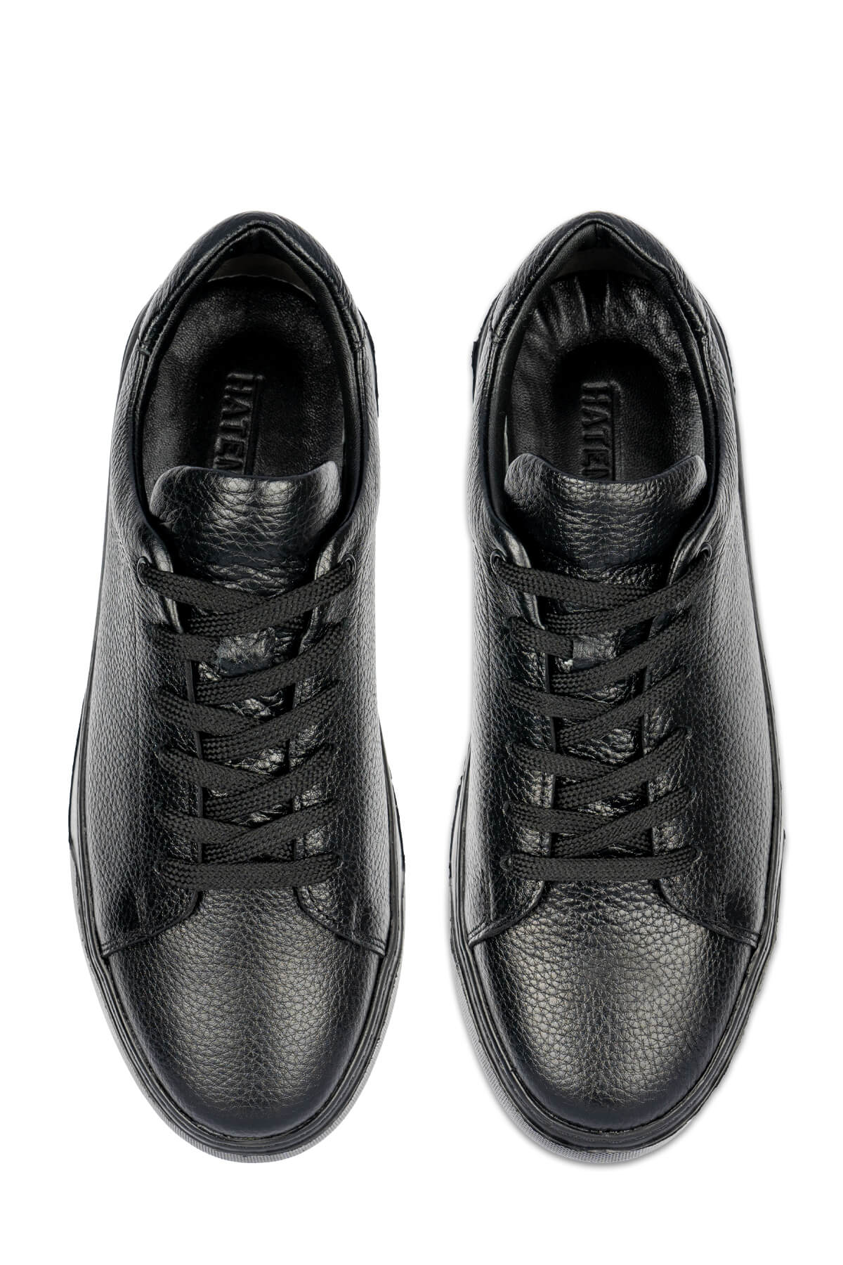 Black leather sneakers with a textured surface and matching laces.