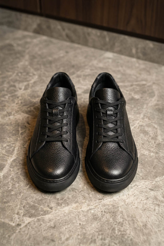 Black leather lace up sneakers featuring textured pebbled leather and matching pebbled leather laces