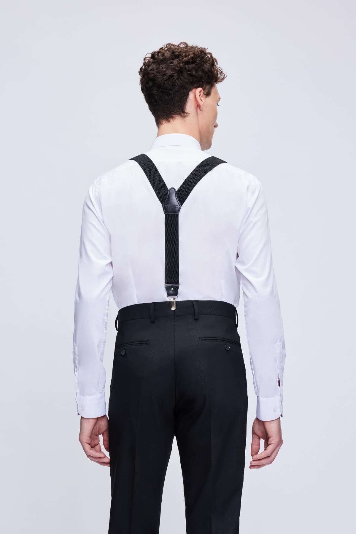 Black leather trim clip suspenders with adjustable straps and matte metal clasps for a sleek secure fit