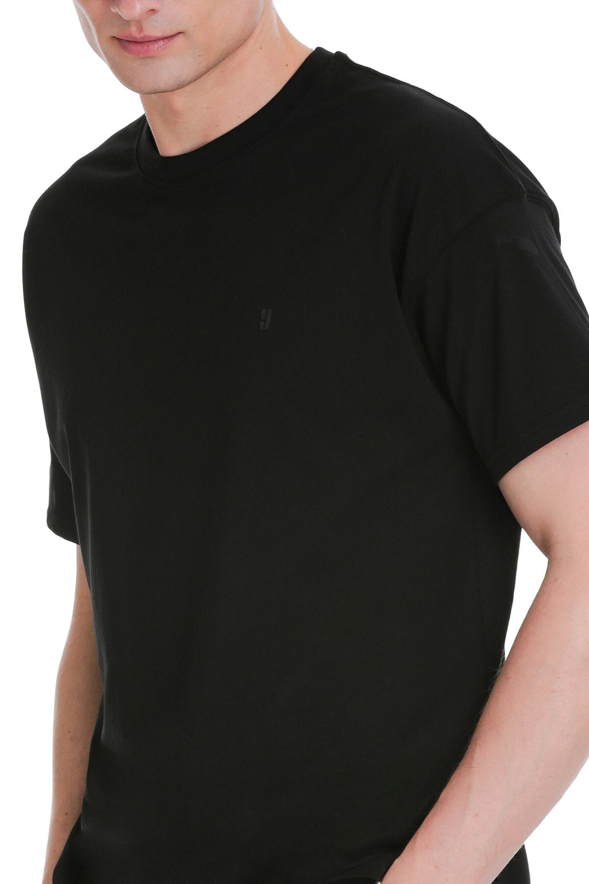 Black oversize crew neck t-shirt with subtle embroidered logo on left chest for casual wear