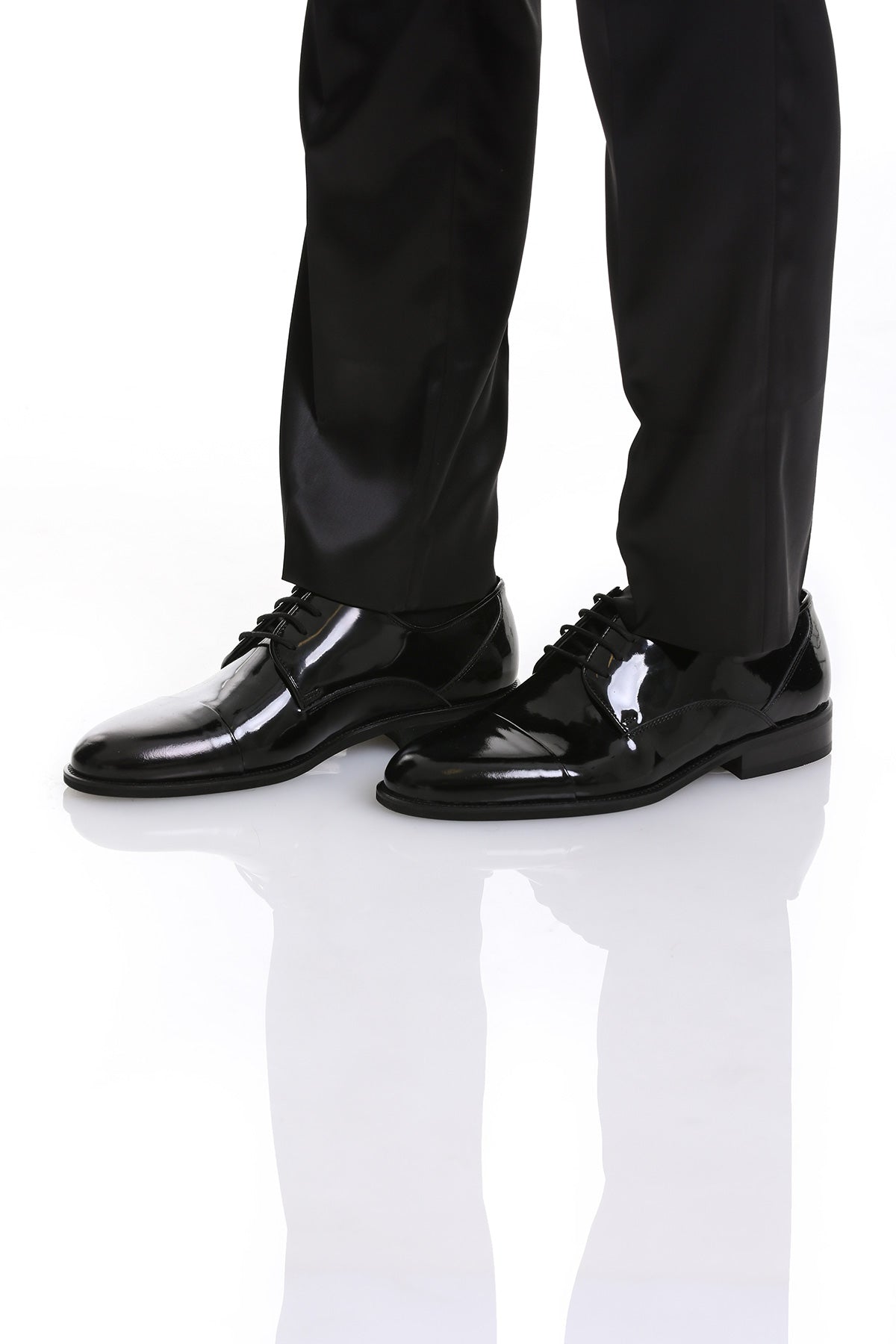 Black patent leather dress shoes with a glossy finish and classic lace-up design.