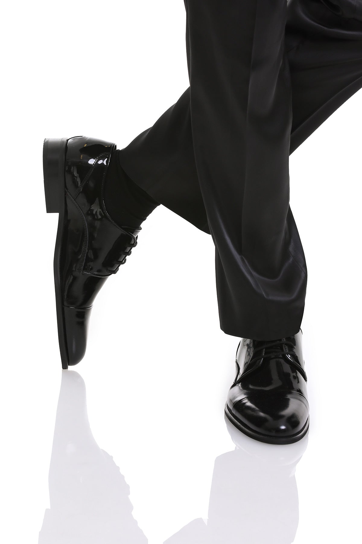 Black patent leather dress shoes with a polished finish and classic lace-up design.