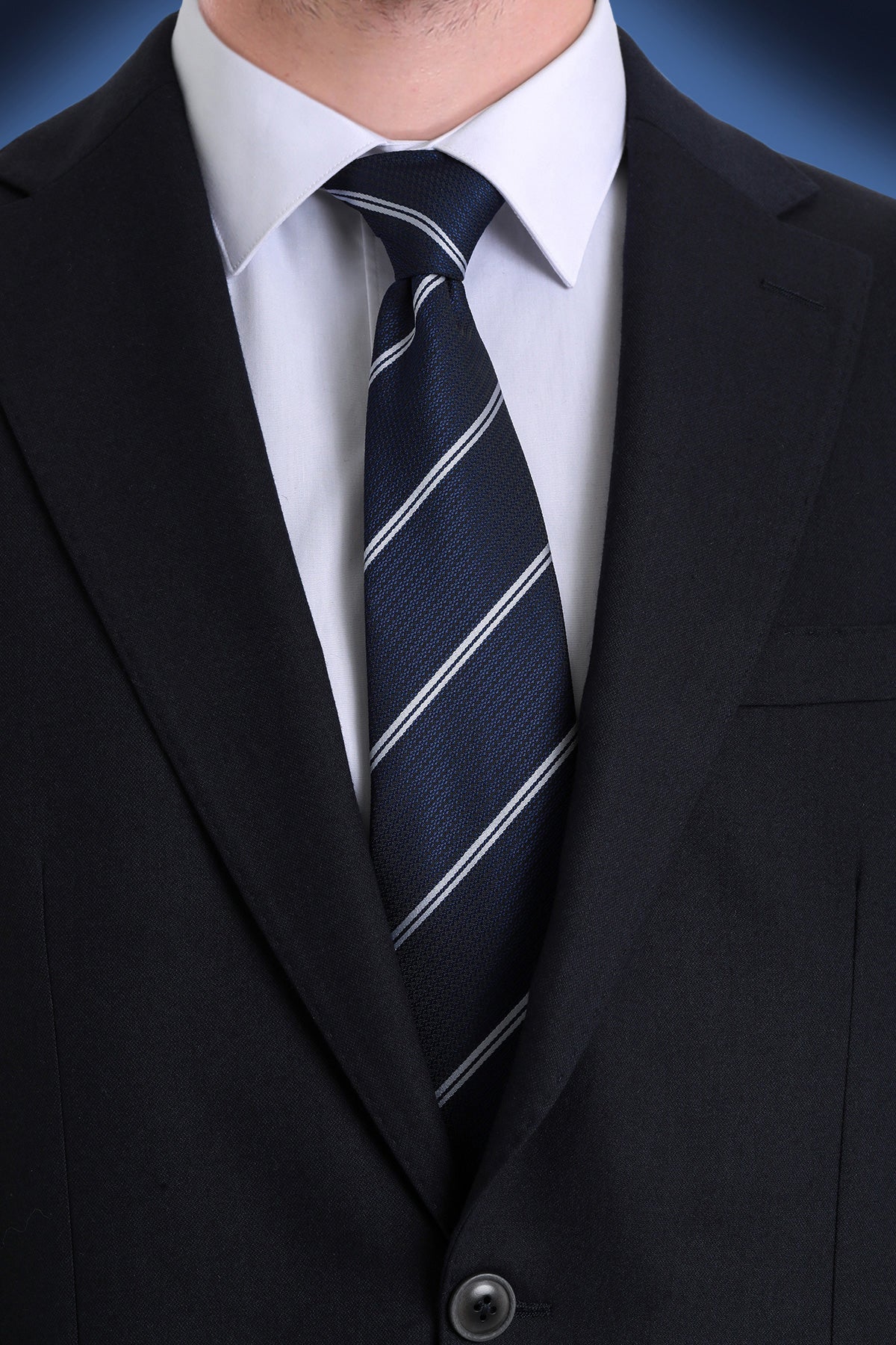 Dark navy tie with crisp white diagonal stripes, crafted from a textured fabric.