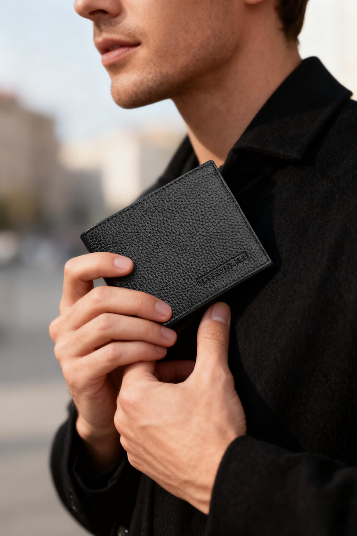 Black textured leather wallet with subtle embossed branding made from genuine leather black for everyday use