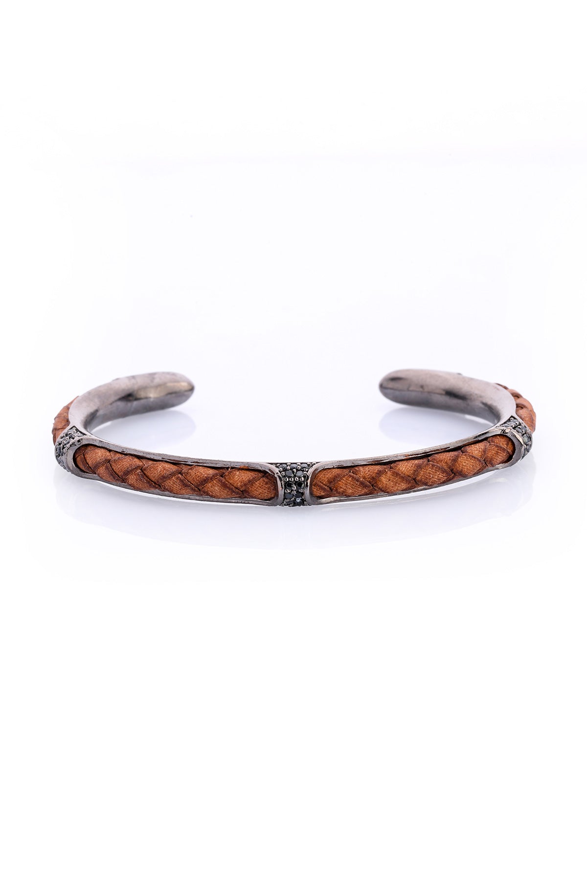 Brown braided leather cuff bracelet with silver-toned metal accents and a central diamond-studded band.