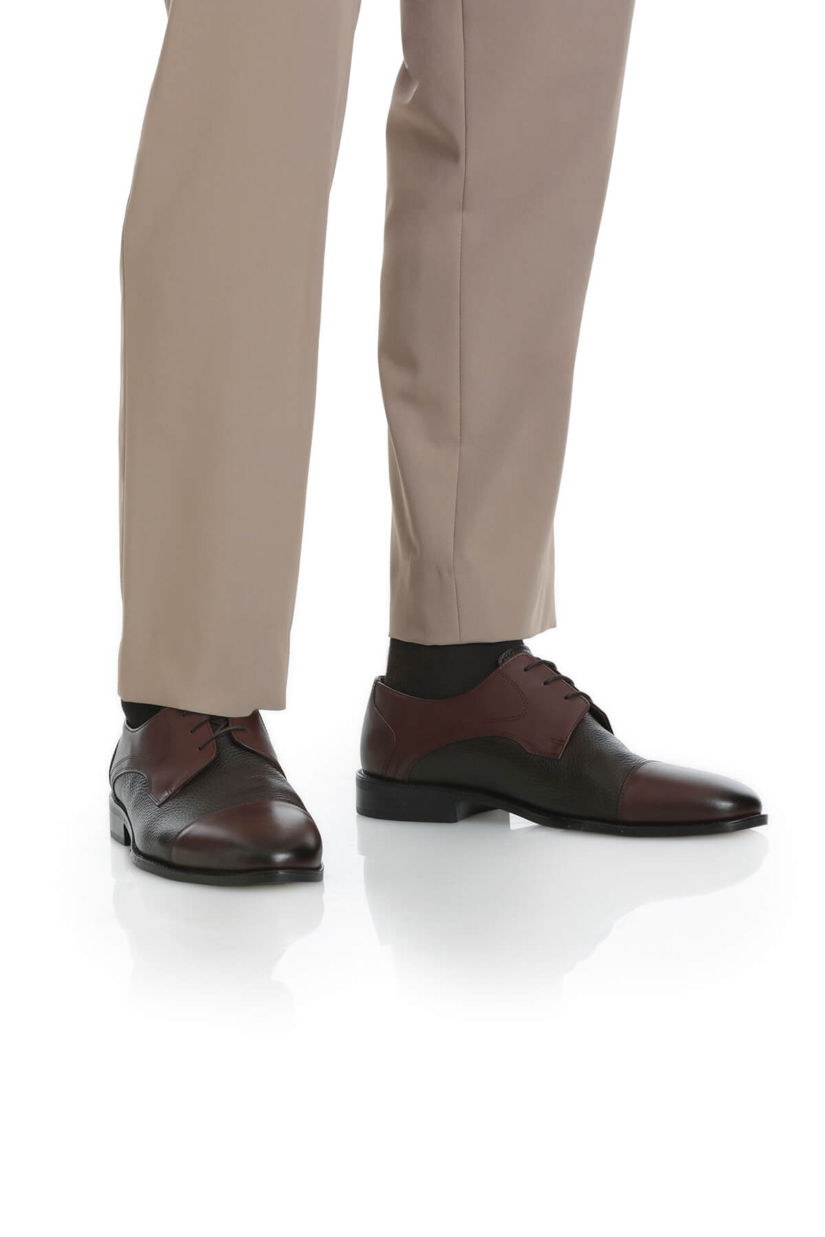 Brown and black two-tone leather oxford shoes with a polished finish.