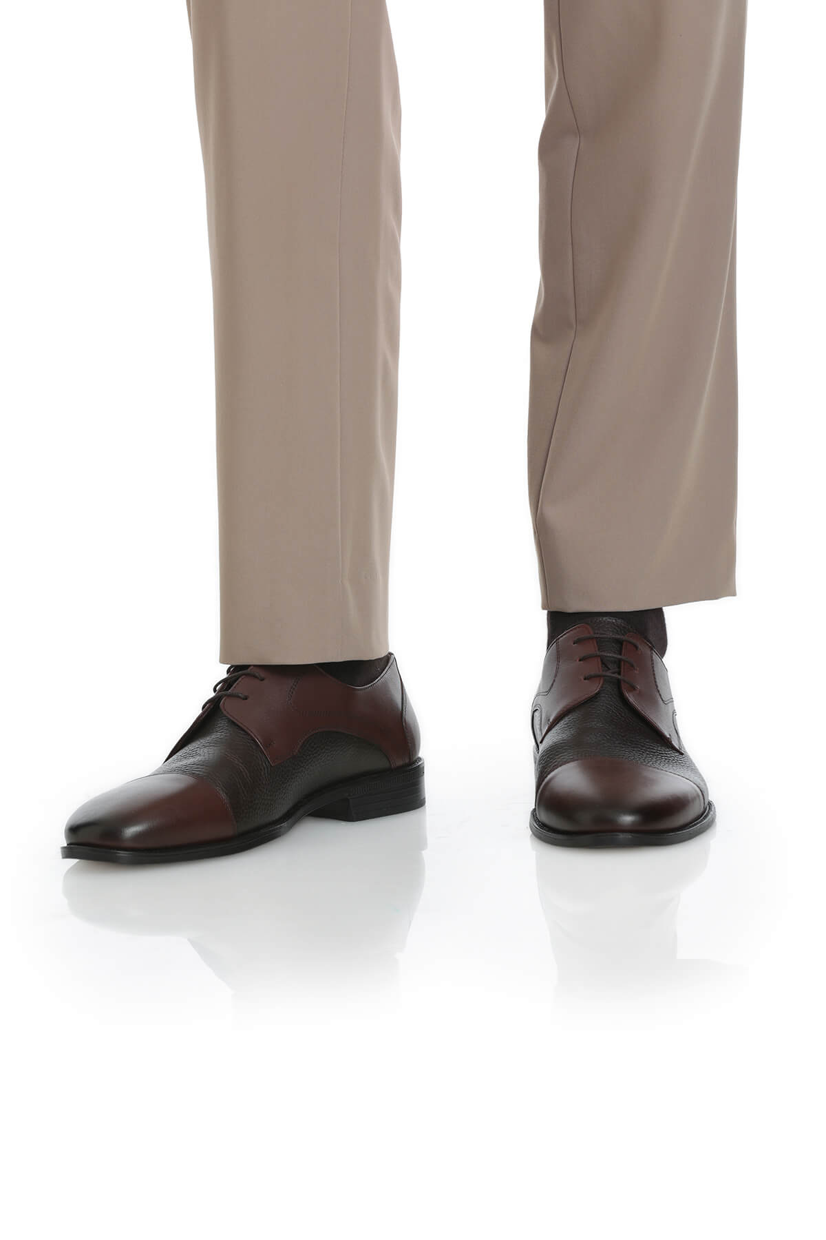 Brown and black two-tone leather dress shoes with a classic oxford design.