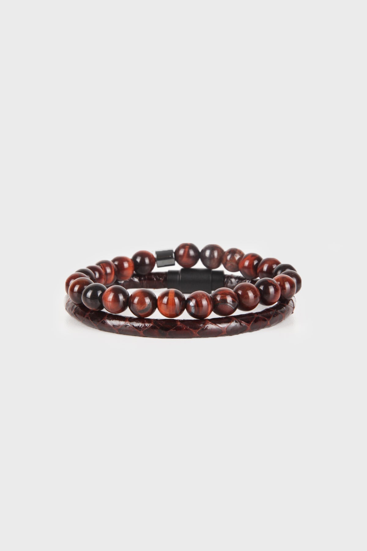 A sleek, two-layered bracelet featuring polished tiger eye beads with a rich amber and dark brown swirl pattern, accented by a matte black magnetic clasp.