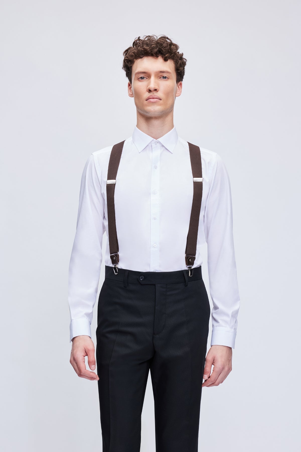 Brown leather trim clip suspenders with silver-toned metal clasps designed for secure and stylish wear