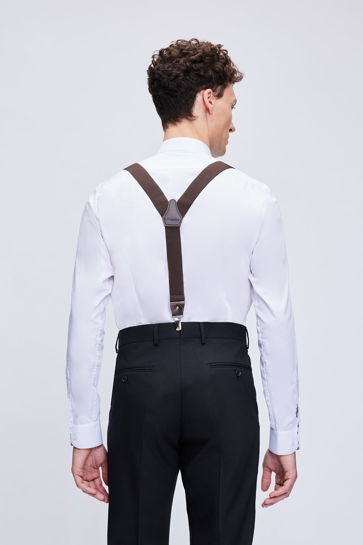 Brown leather trim clip suspenders with adjustable straps and metallic clasps for a stylish secure fit