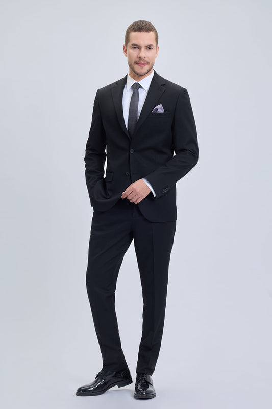 Black muscle fit notch lapel suit with subtle texture paired with matching trousers and polished black dress shoes