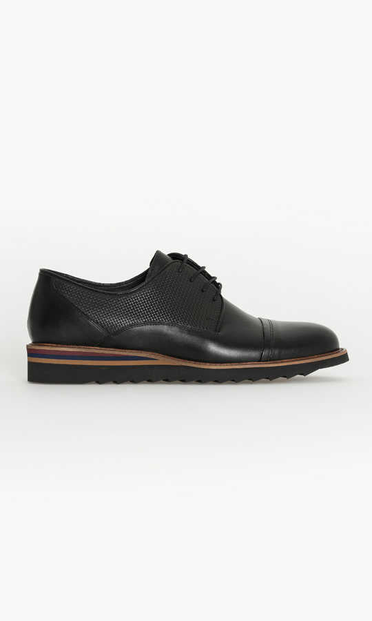 Black leather derby shoe with a perforated panel and multicolored stripe along the sole.