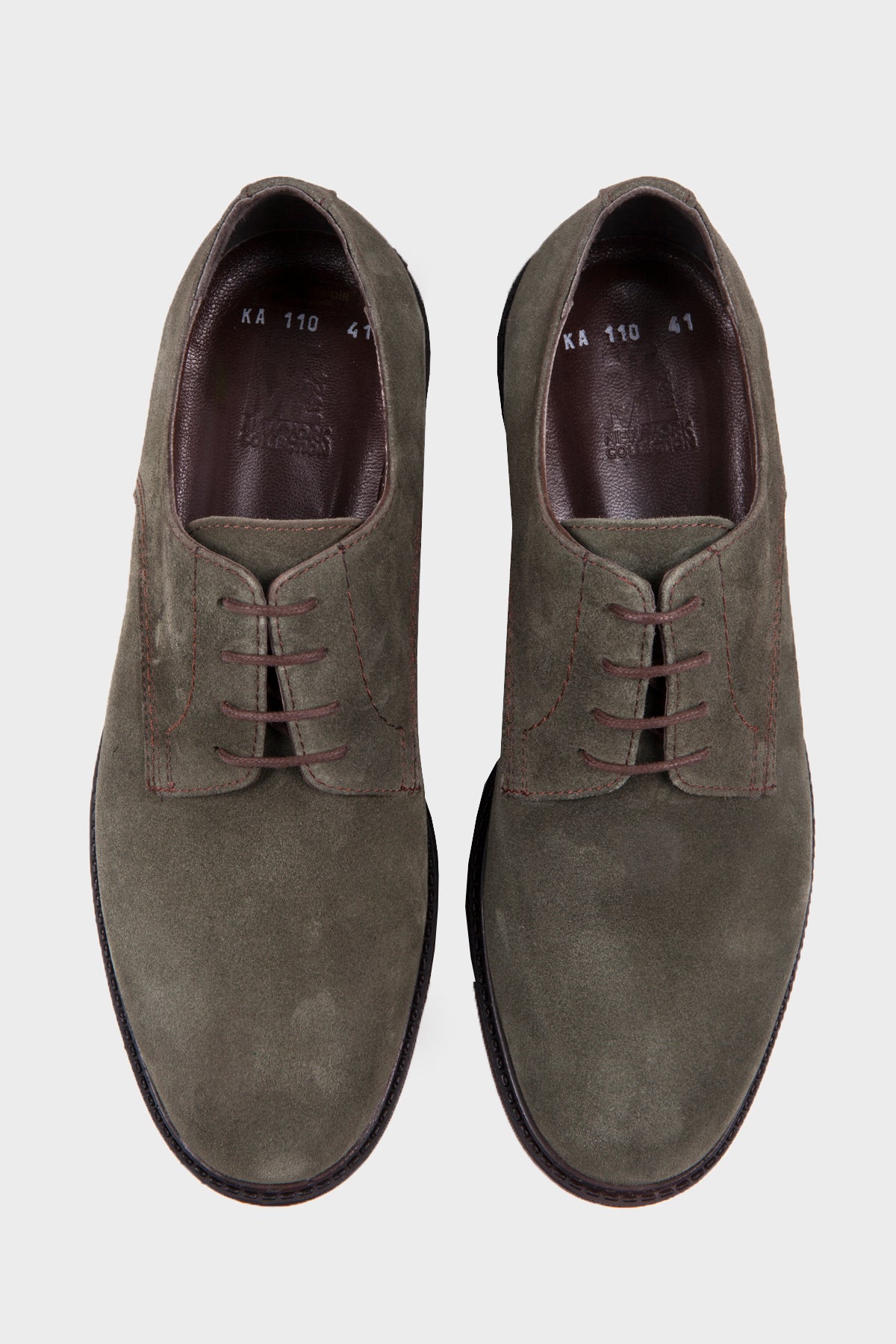 A pair of olive green suede lace-up dress shoes with dark brown laces and a classic oxford design.