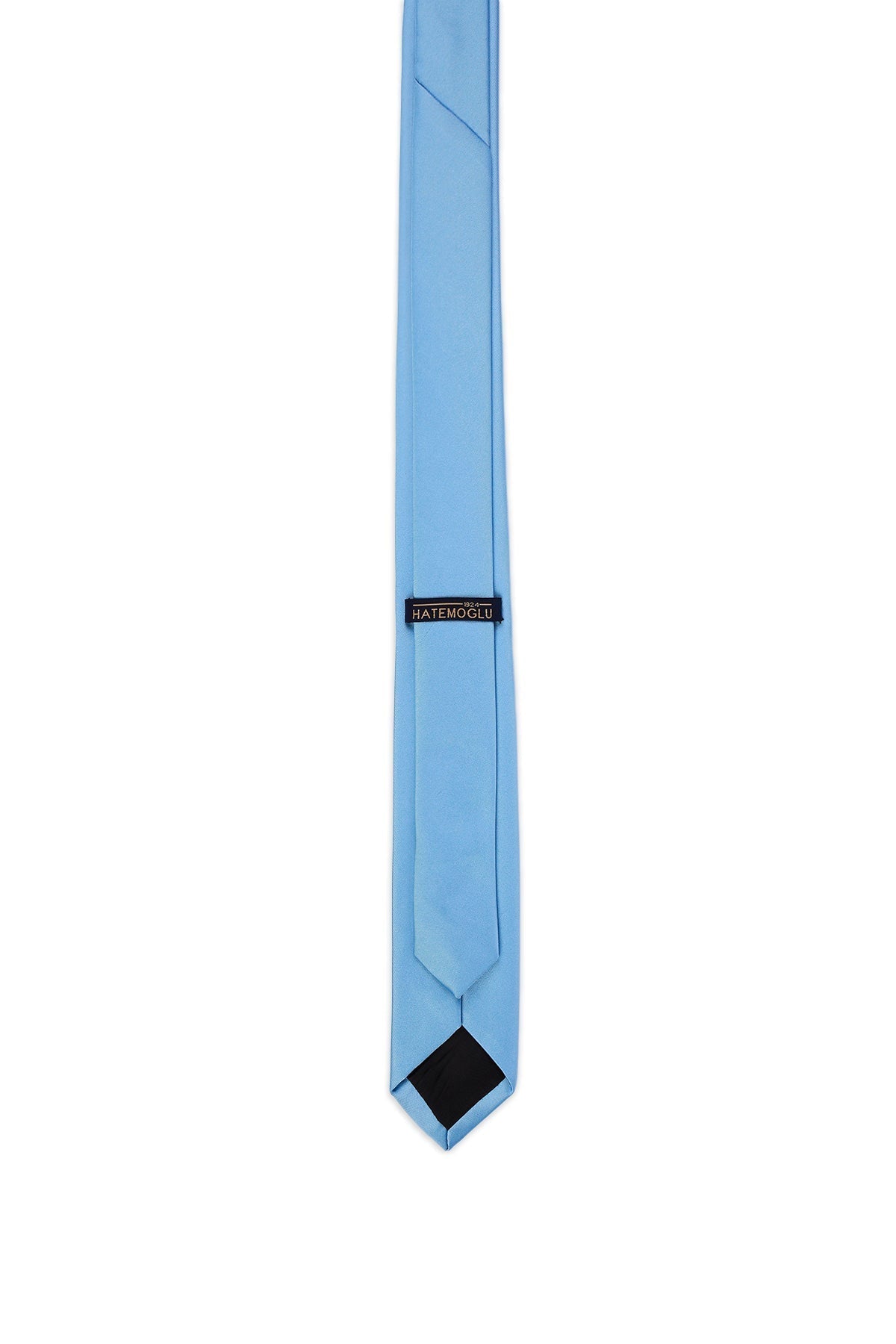A light blue satin tie with a black inner lining and a small black label reading ’hatemoslit’ near the top.