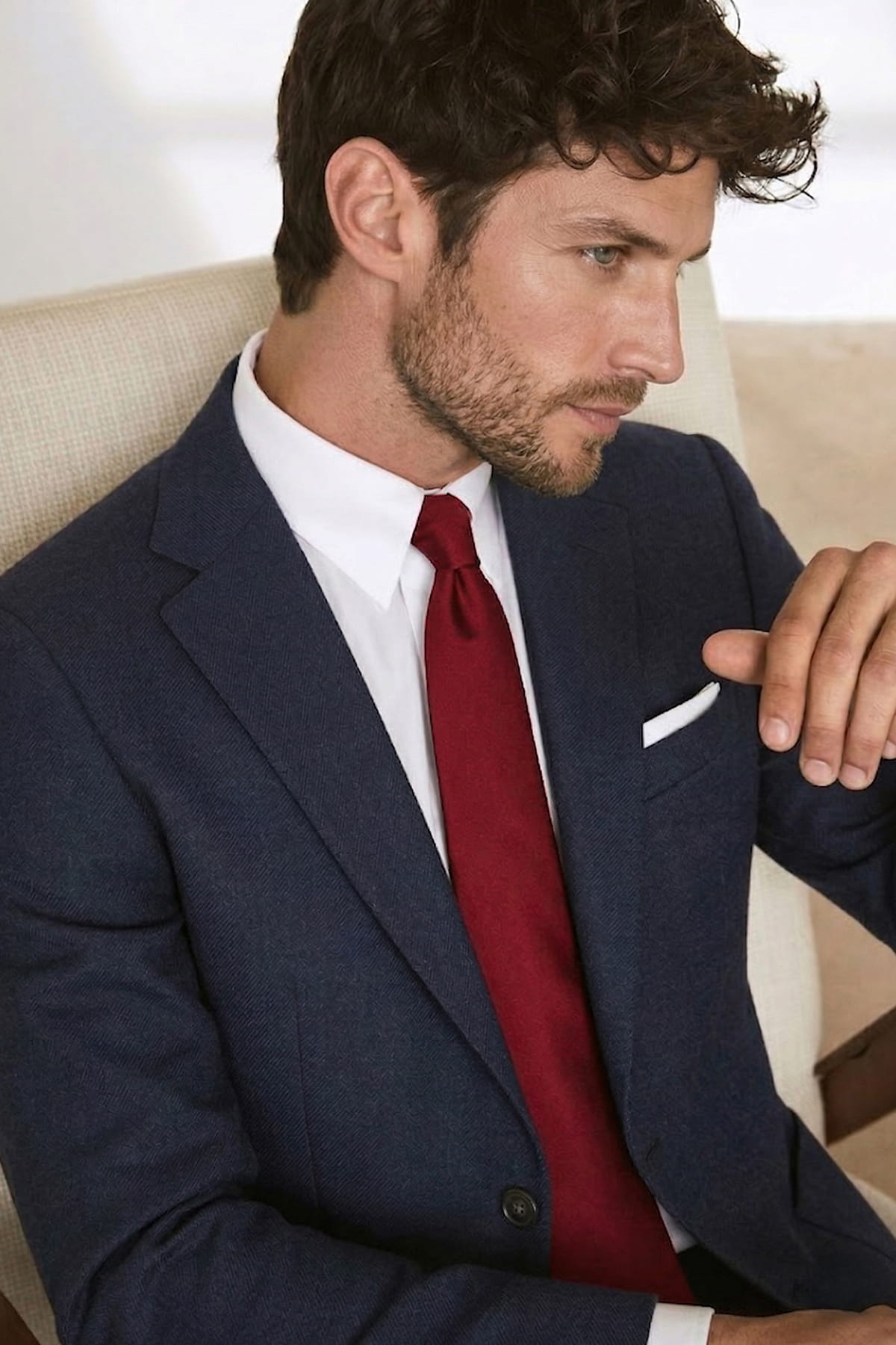 Navy blue textured suit jacket with crisp white shirt and casual 2.36 inches red tie made of micro polyester