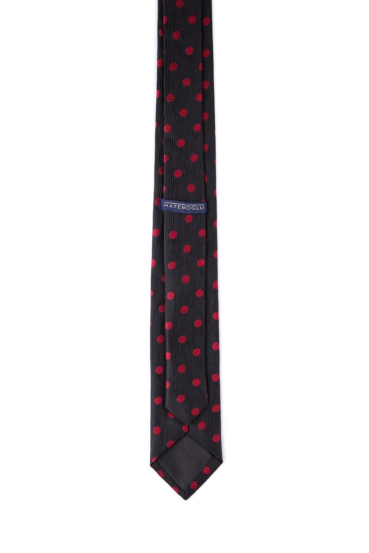 Black tie with red polka dots, featuring a subtle ribbed texture and a branded label.