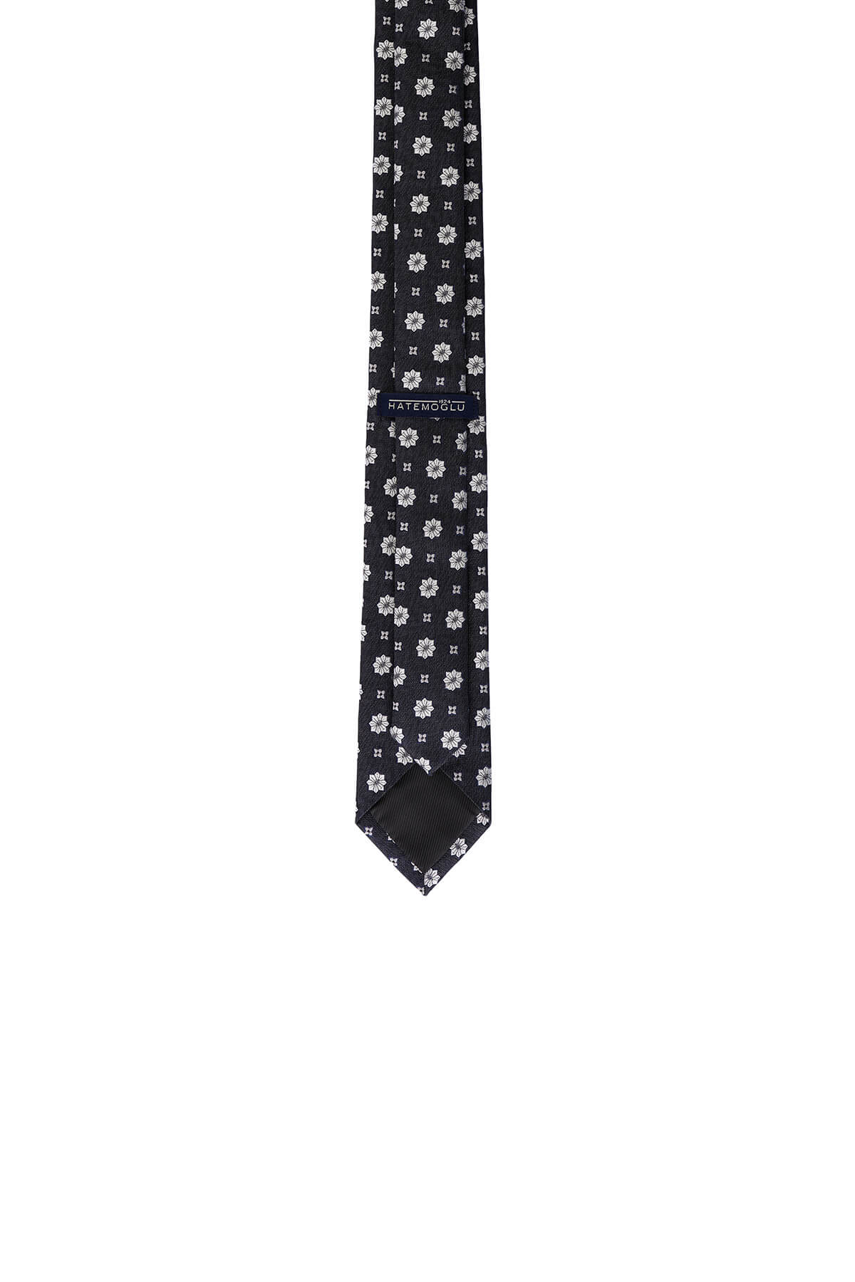 Black tie with a subtle pattern of small white floral motifs.