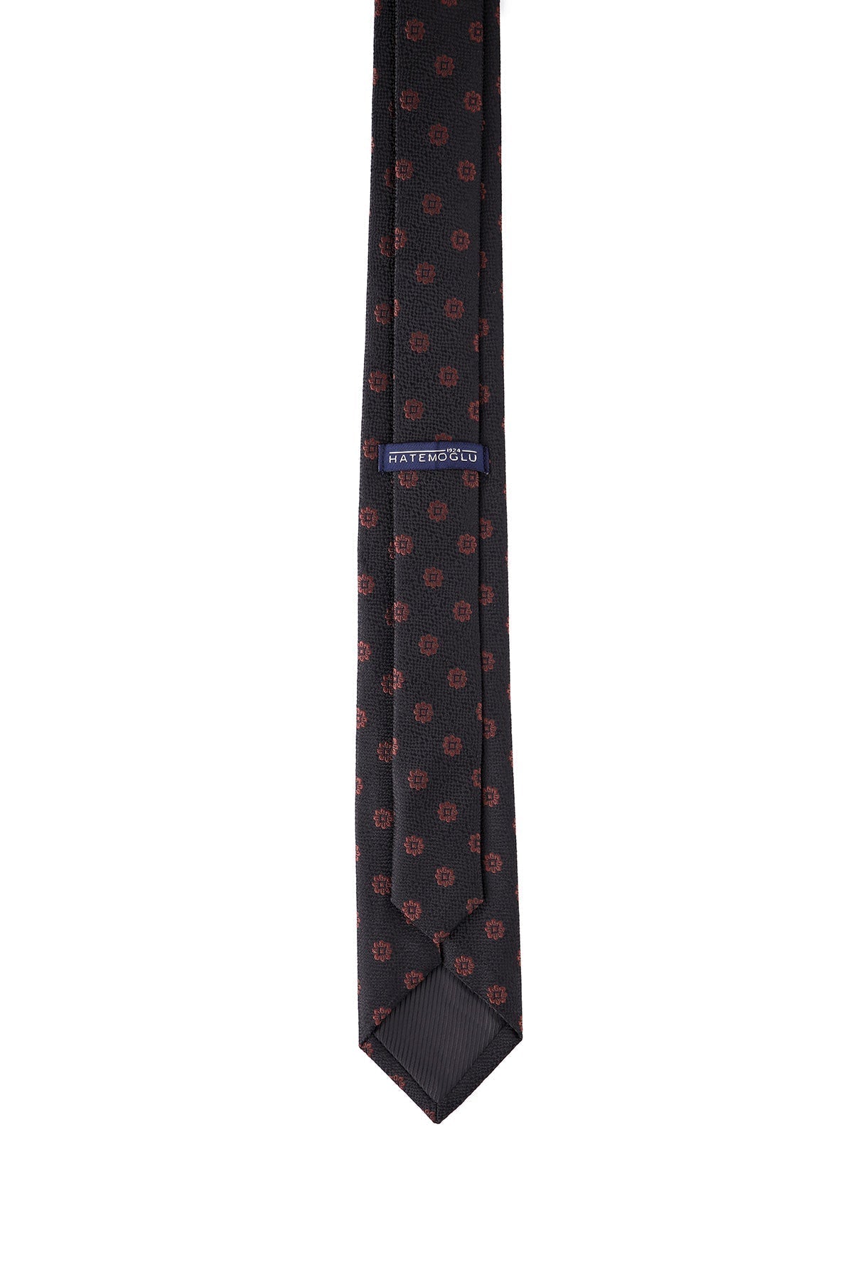 A dark gray tie with a subtle pattern of small, repeating red geometric shapes and a blue brand label reading ’hatemoulo’ near the top.