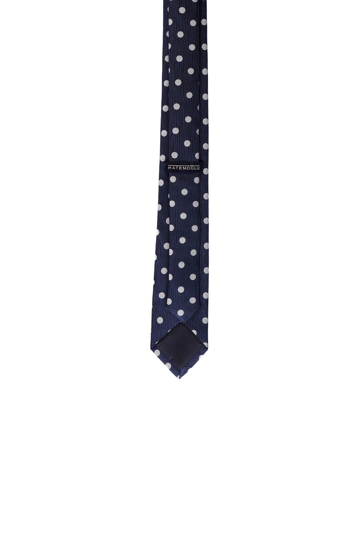 A navy blue silk tie with a subtle striped texture and evenly spaced white polka dots, featuring the ’mayoral’ brand label near its center.