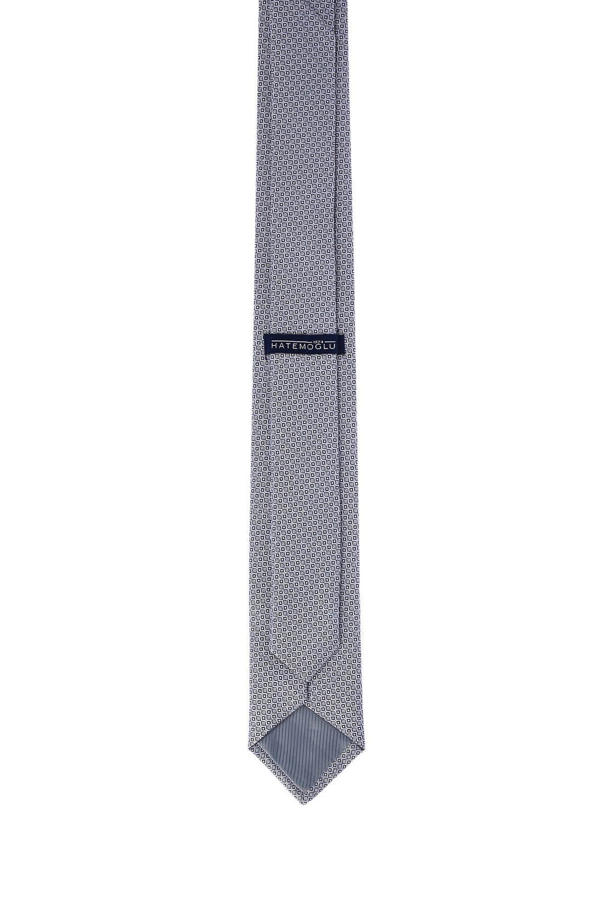 A sleek, gray tie with a subtle geometric pattern and a branded label.