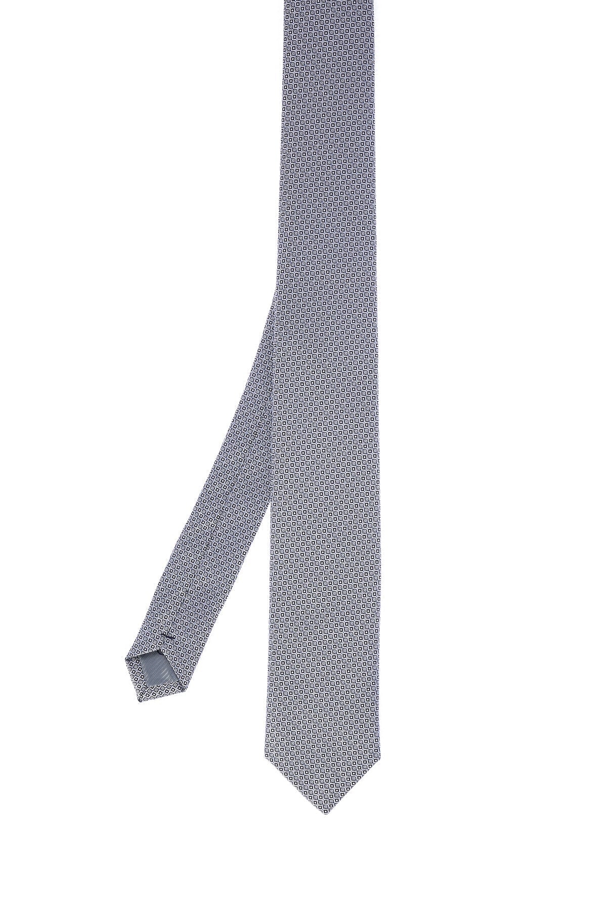 A sleek, light gray tie featuring a subtle geometric pattern of small, repeating hexagons in a darker shade.