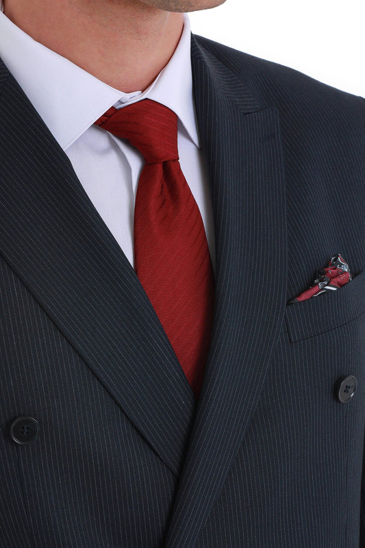 A rich burgundy silk tie with a subtle textured weave, neatly knotted against a crisp white dress shirt and dark pinstripe suit.