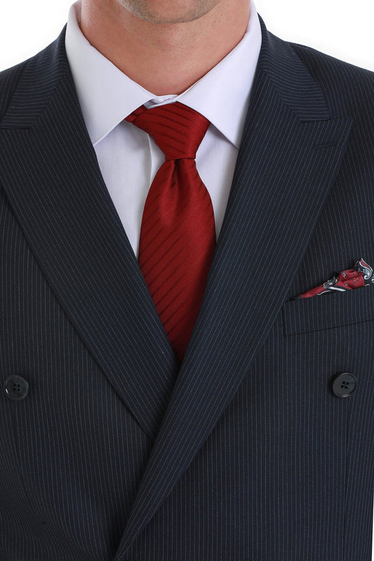A rich red silk tie with a subtle diagonal ribbed texture, neatly knotted against a white dress shirt and dark pinstripe suit.