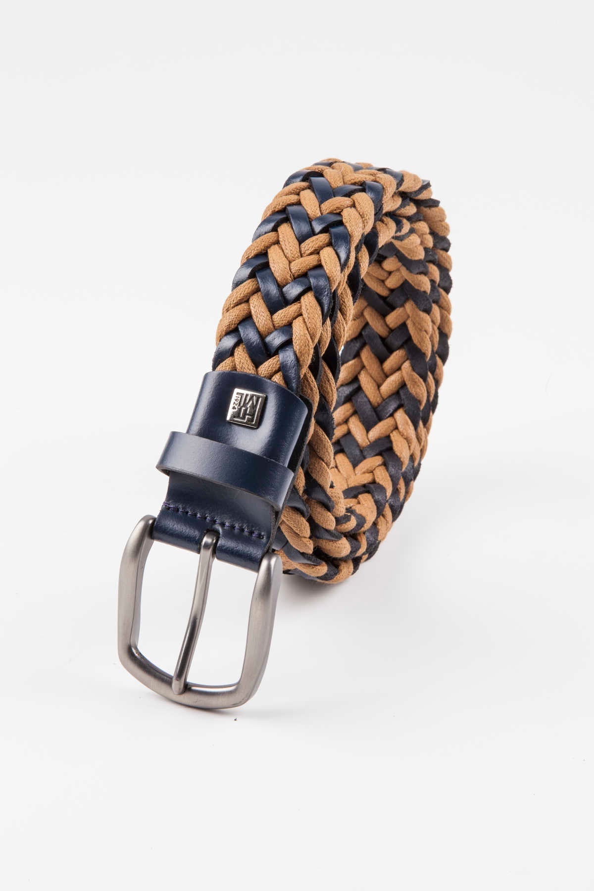 A braided leather belt with navy and tan woven strands, featuring a silver-toned buckle and a matching navy leather tab.