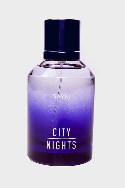 A sleek, gradient purple glass perfume bottle with a dark blue cap and white lettering that reads ’sayki city nights.’