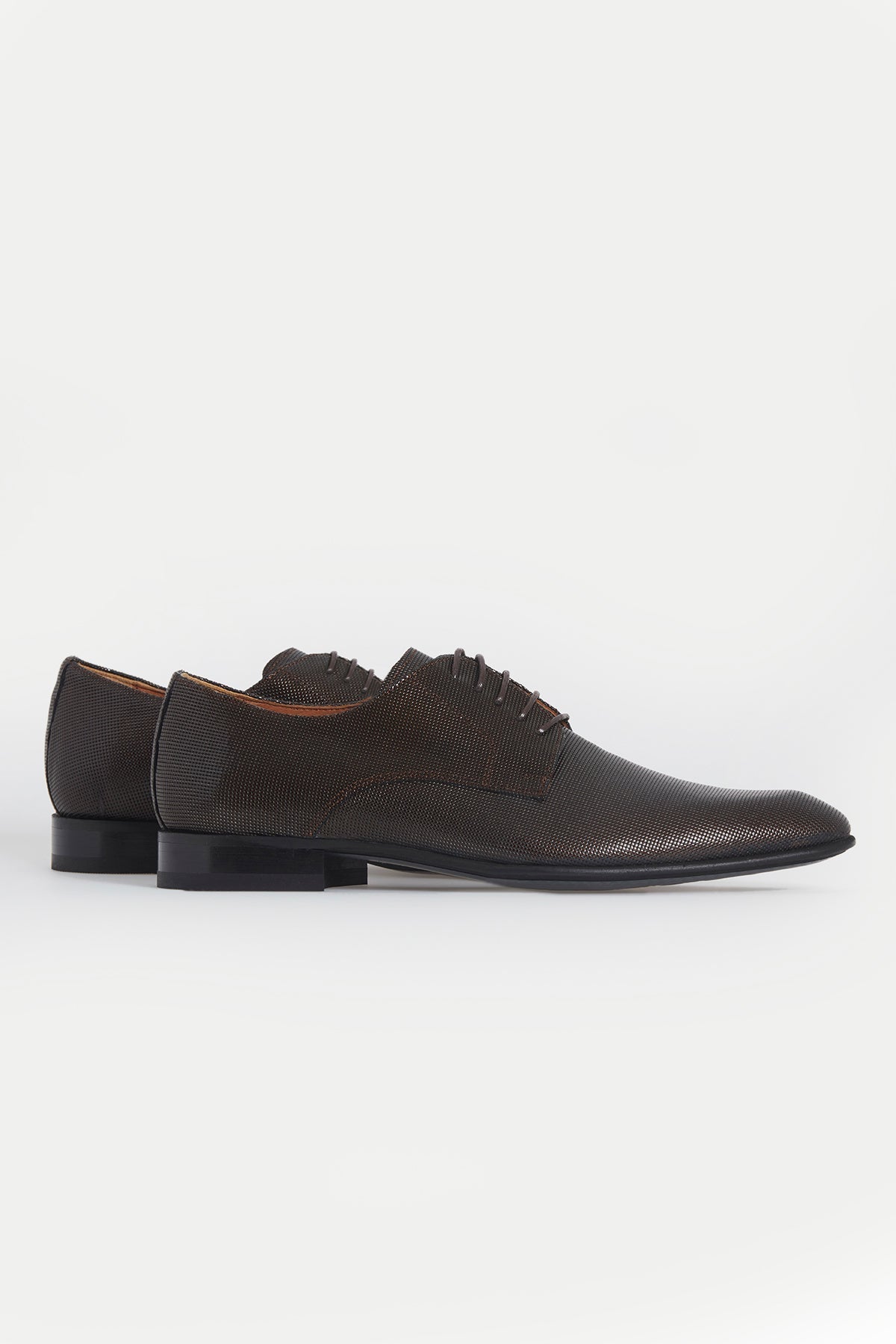 Black perforated leather men’s dress shoes with a classic oxford design and dark laces.
