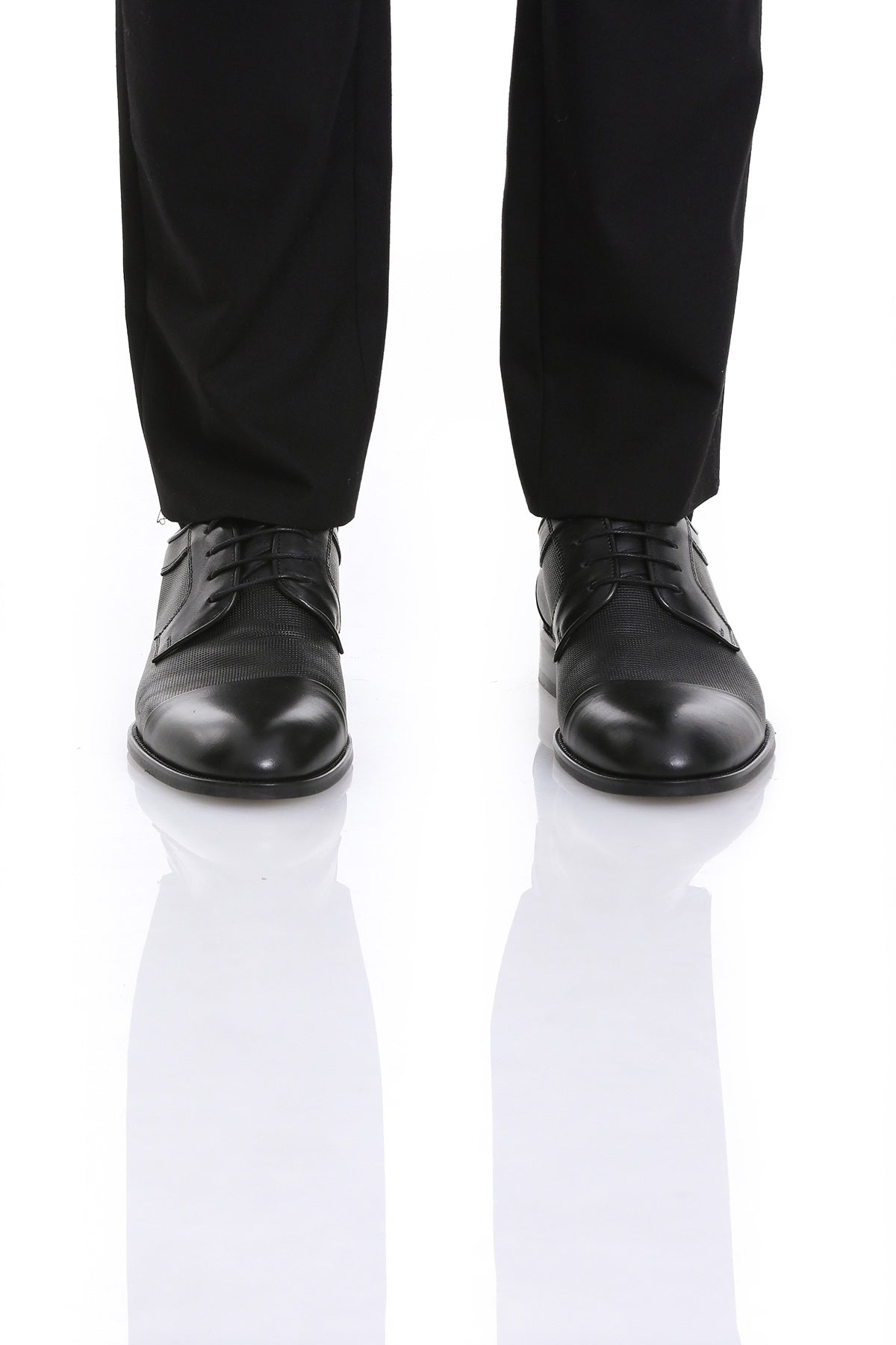 Black leather lace-up dress shoes with a polished toe cap and subtle textured panels.