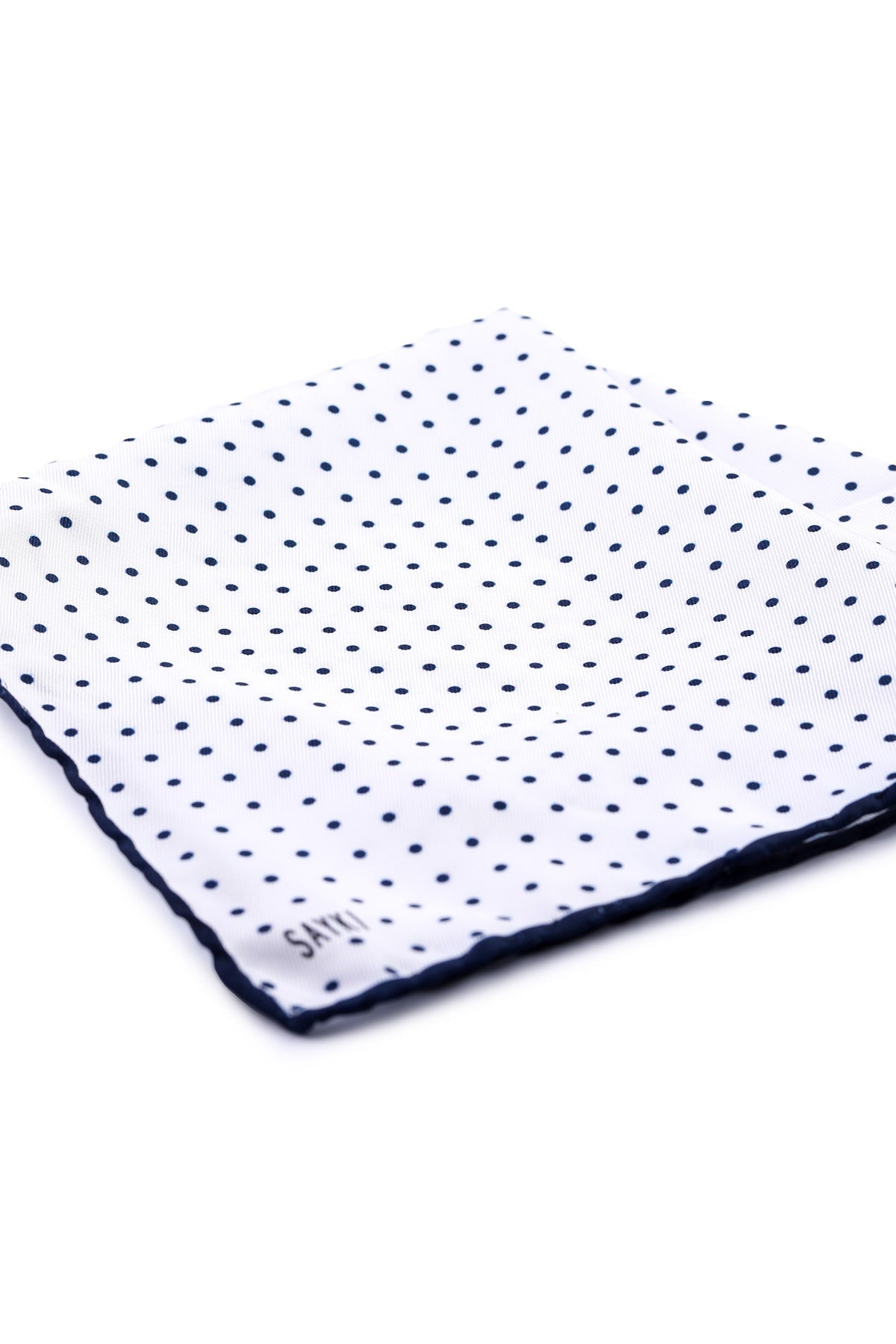 White pocket square with navy blue polka dots and a matching navy blue border.
