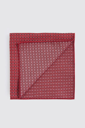 A red pocket square with a subtle geometric pattern and a slightly textured fabric.