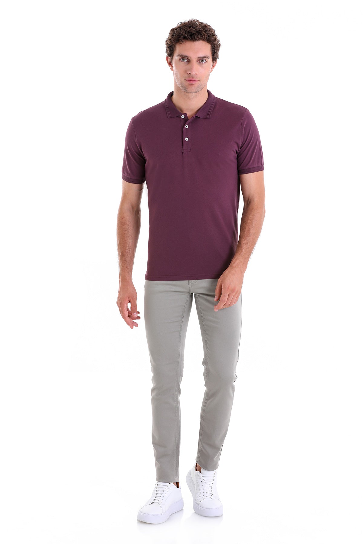 A man wearing a maroon short-sleeved polo shirt with white buttons and a classic collar.
