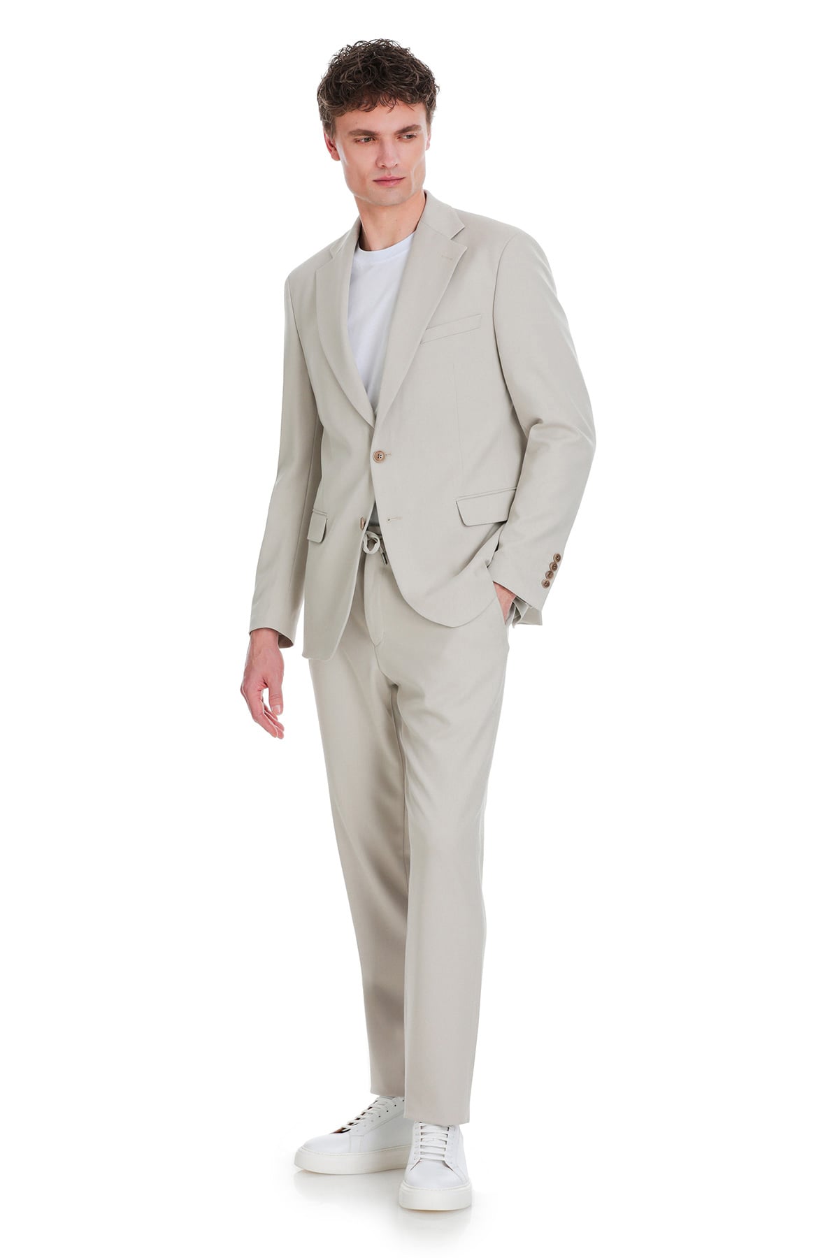 A sleek comfort fit beige notch lapel classic suit with a tailored fit and subtle texture perfect for formal wear