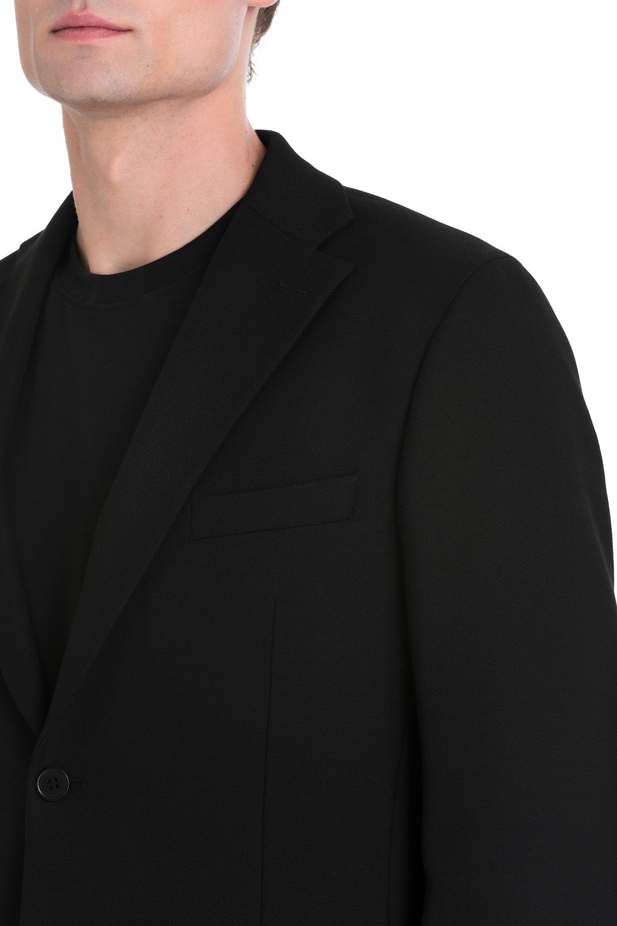 Black tailored blazer with a sleek, minimalist design and single button closure.