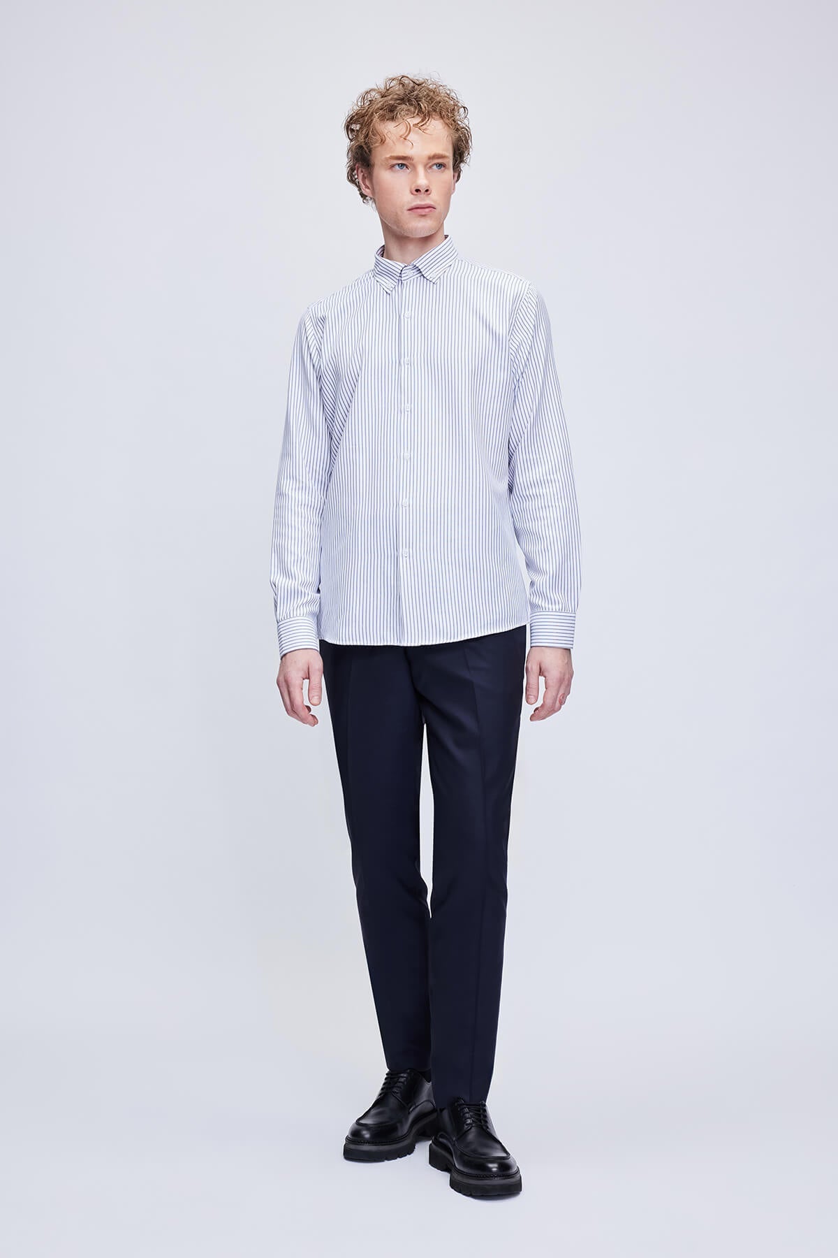 A crisp white and navy blue vertically striped long-sleeved button-down shirt with a classic collar.