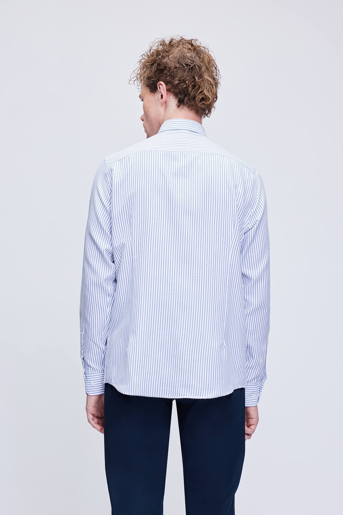 A crisp white and navy blue vertically striped long-sleeved dress shirt with a classic collar.