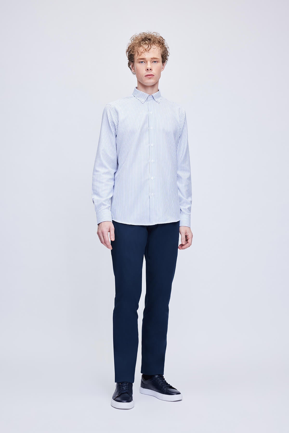 A crisp, long-sleeved button-down shirt with fine vertical stripes in light blue and white.