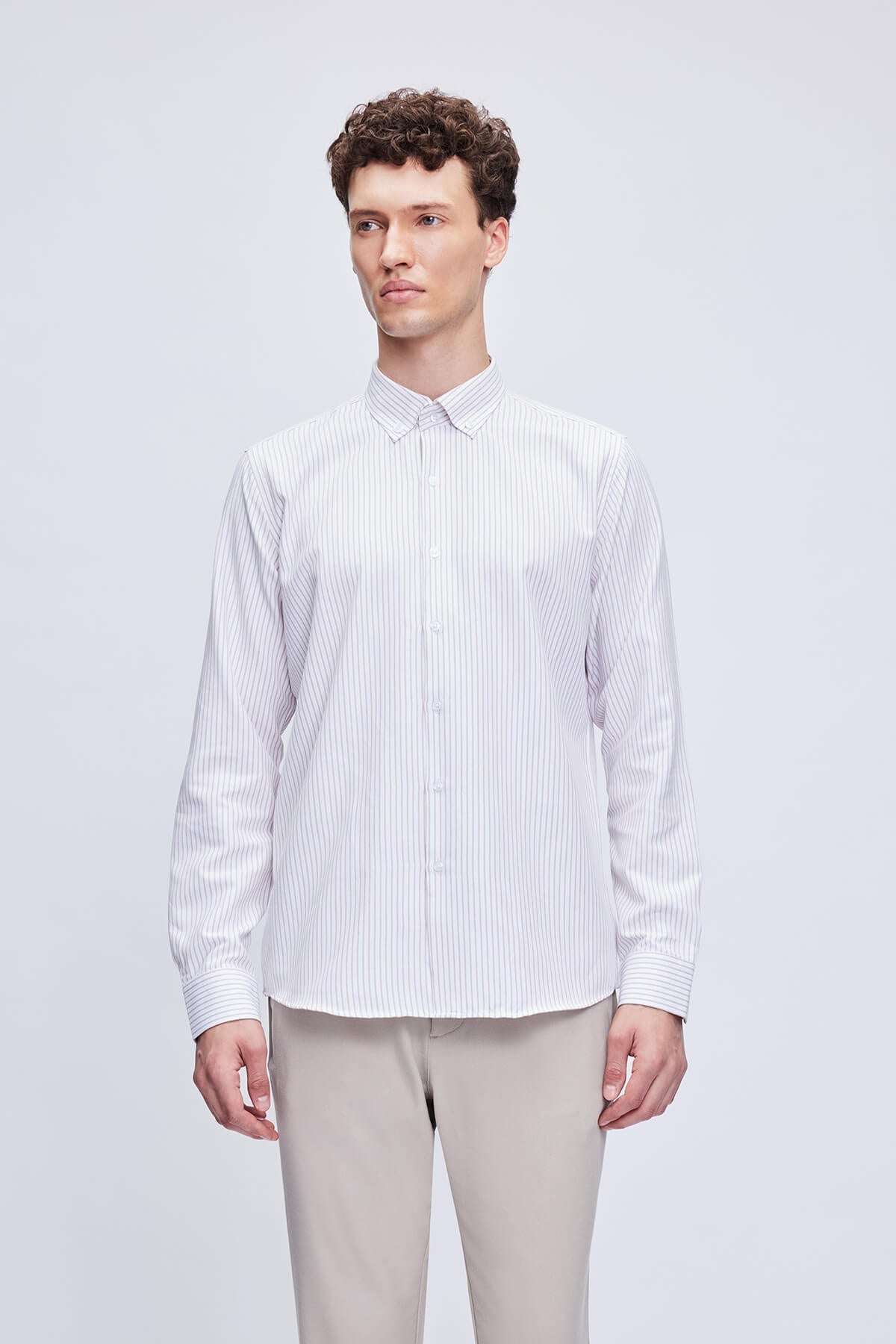 White long-sleeved button-down shirt with fine vertical stripes.