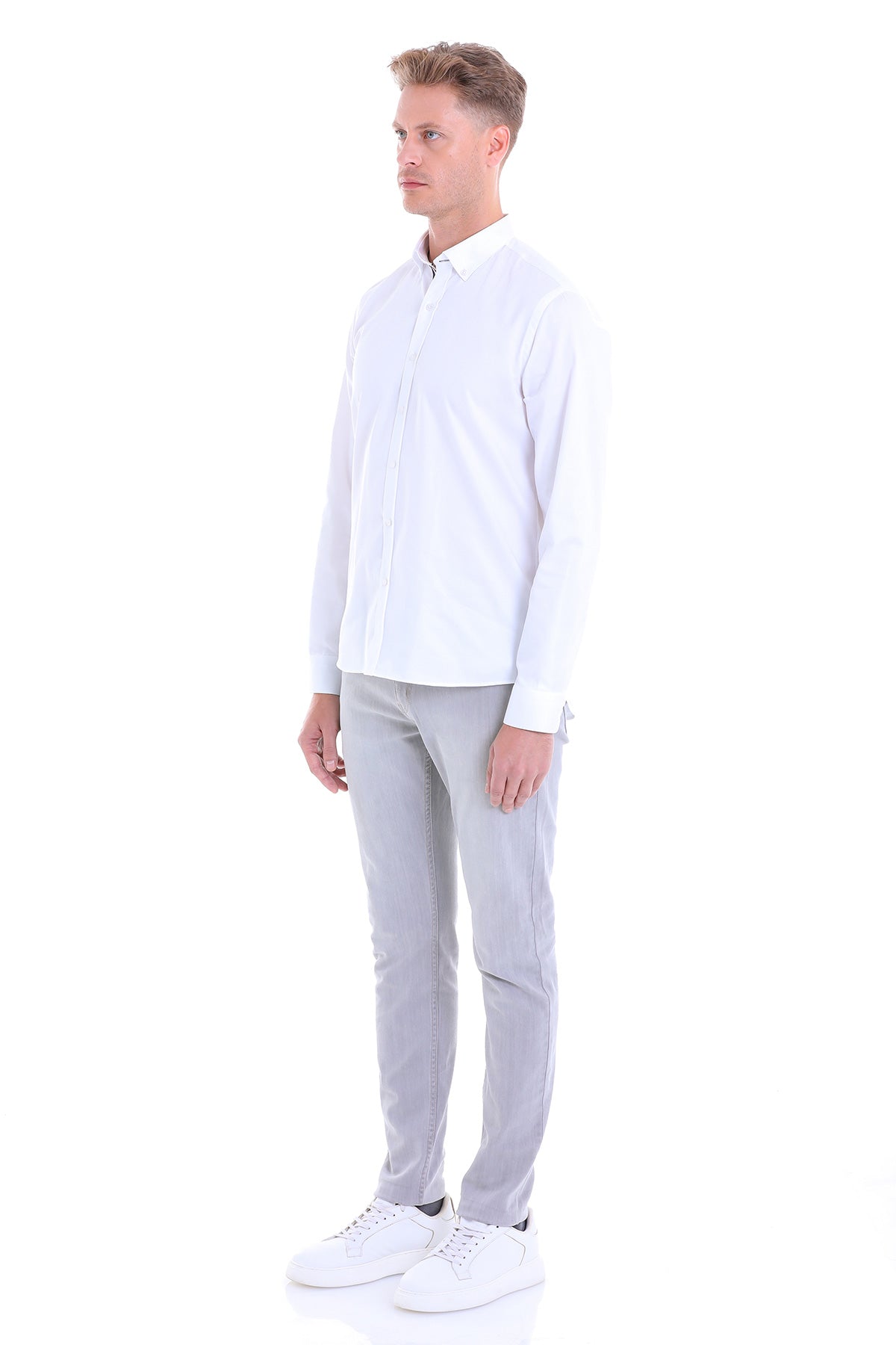 A crisp white long-sleeved button-up shirt with a classic collar and neatly pressed fabric.