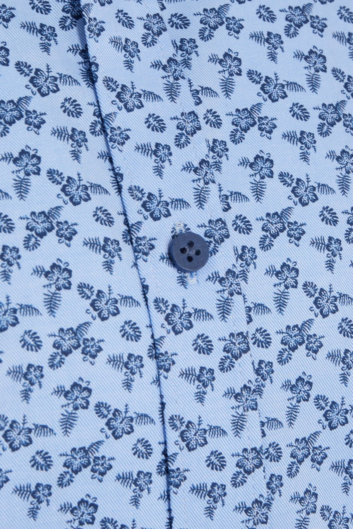 Light blue button-down shirt with a delicate dark blue floral and fern pattern.