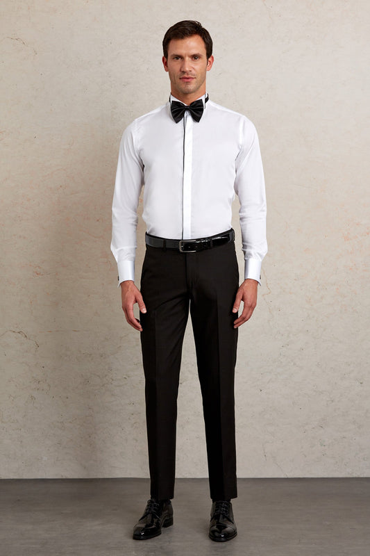 White dress shirt with black bow tie and matching black trousers.